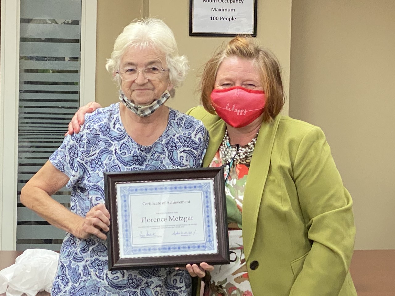 Florence Metzgar, left, receives a certificate recognizing her 10,000th trip using her MoGo card with Pocono Pony from Peggy Howarth, executive director of MCTA, on Sept. 30, 2021. [MCTA photo. Image Copyright Reserved for MCTA only. Do not copy.]